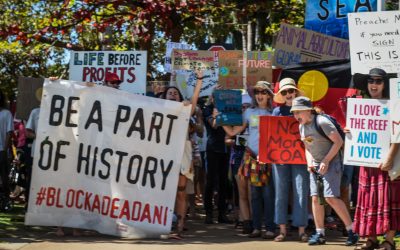 Adani prosecuted in court as thousands march for climate action